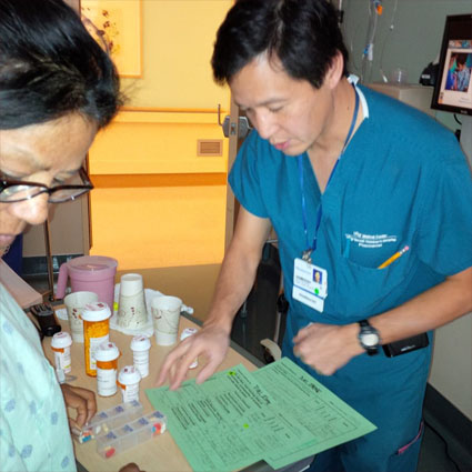 Pharmacist David Quan conducting a final MEDS review with Irene